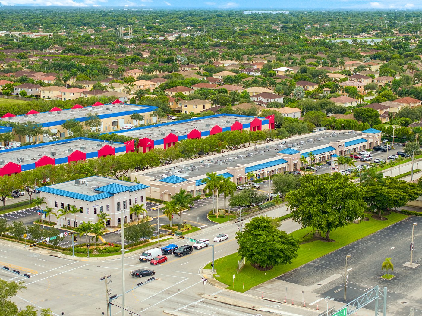 Aerial view of Cortland Commercial Center buildings with red entry towers and blue roofs, Southwest Miami-Dade
