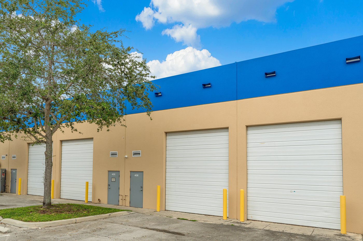 Roll-up loading doors under a blue parapet at Cortland Commercial Center II