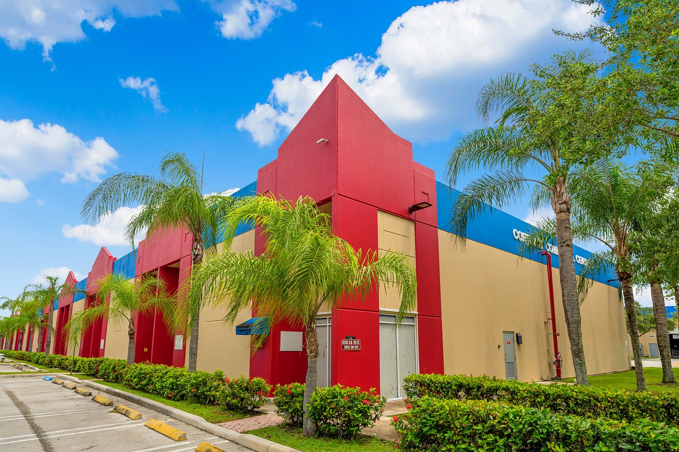 Red entry tower framed by palm trees at Cortland Commercial Center II