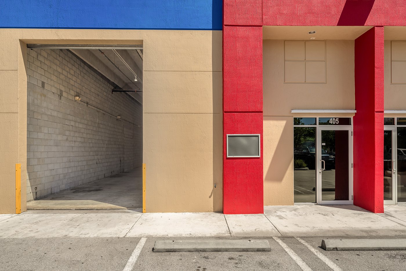 Open roll-up door and storefront entrance at Zacarias Commercial Center III