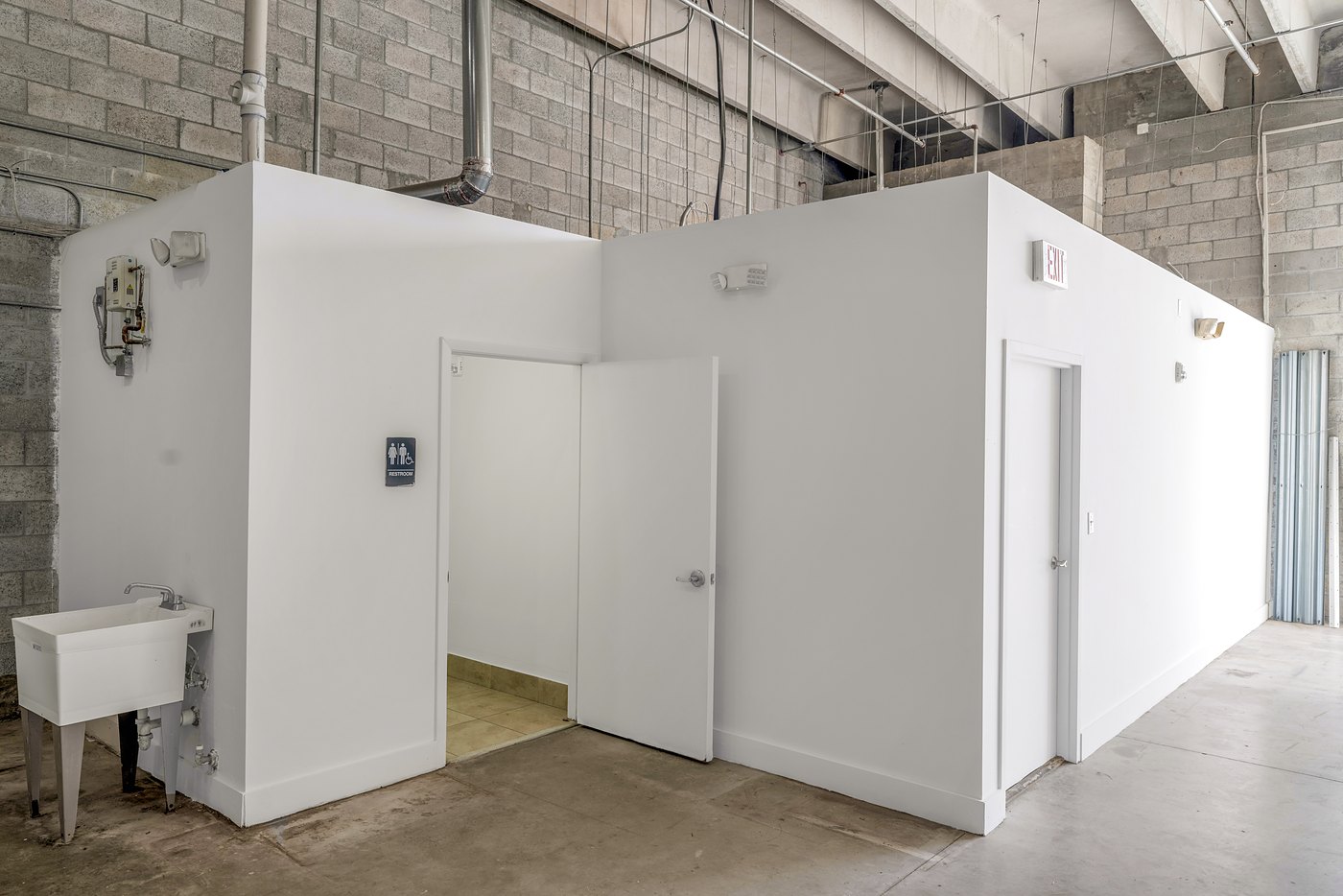 Restroom and office build-out with a utility sink inside the warehouse, Zacarias Commercial Center III